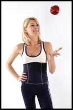 Woman tossing apple into air