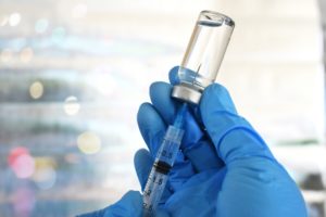 filling syringe with vaccine