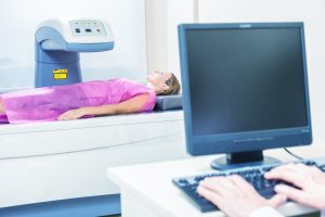 woman undergoing bone density test on DXA machine